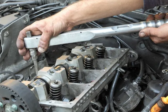 Diesel mechanic servicing engine near Dallas